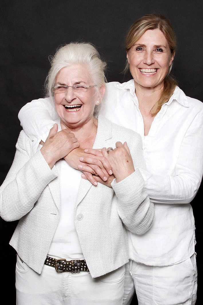 Fotostudio Fotografin Familienfotos Fotoshooting Generationenfotos 2 lachende Frauen Mutter Tochter in weißer Kleidung